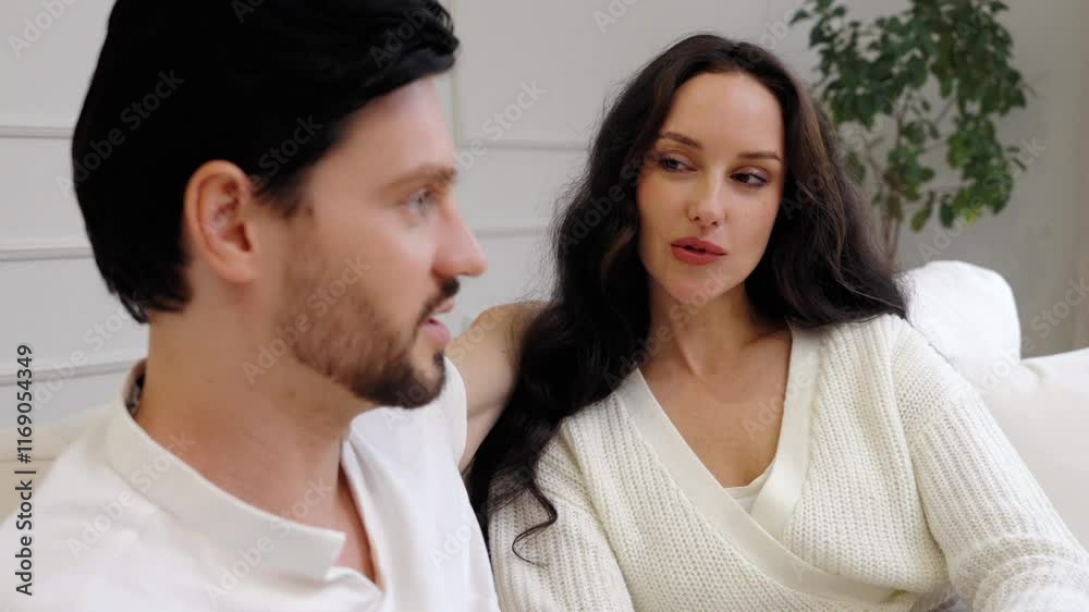 Engaging conversation between a man and woman in a modern living room Engaging conversation between a man and woman in a modern living room