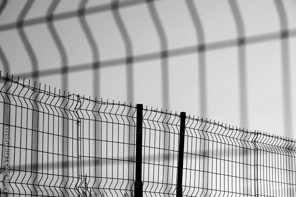 Obraz premium Barbed wire net Fence Sunset isolated on white background. sunset behind the wires. Mesh Steel and Barbed Wire, Sunset with Red and blue heaven. illustration.