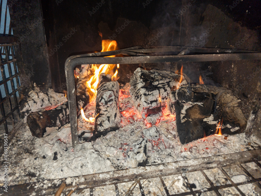 fire prepared in the field, to start preparing food, with its good embers and its trebeds, well fenced to avoid danger, with the black walls of previous bonfires fire prepared in the field, to start preparing food, with its good embers and its trebeds, well fenced to avoid danger, with the black walls of previous bonfires
