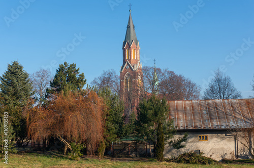 Church of the Transfiguration of the Lord (kościół Przemienienia Pańskiego) rises above town. Libiąż, Poland. photo