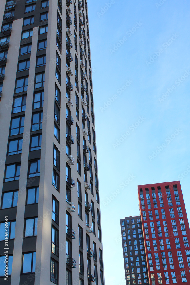 Obraz premium modern high-rise building under construction in a new residential complex, modern architecture in the city, facades of new buildings