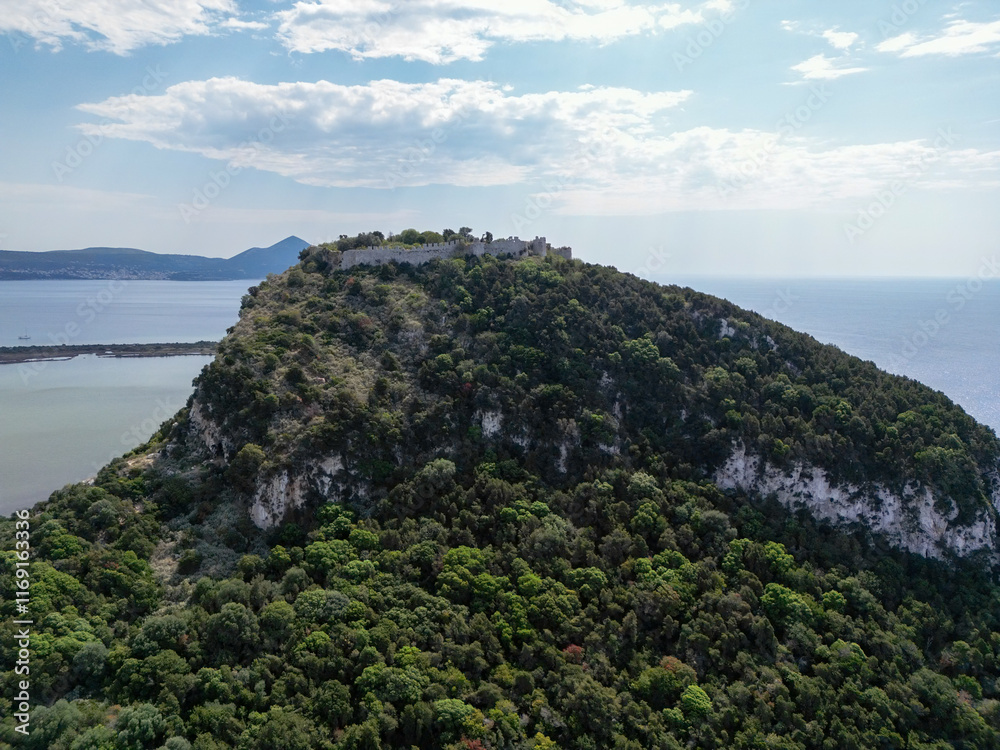 Aerial View of Historic Hilltop Fortress Surrounded by Lush Greenery and Coastal Scenery in Greece Aerial View of Historic Hilltop Fortress Surrounded by Lush Greenery and Coastal Scenery in Greece