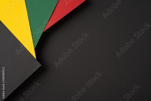 Abstract arrangement of vibrant colored papers against a black backdrop, ideal for designs