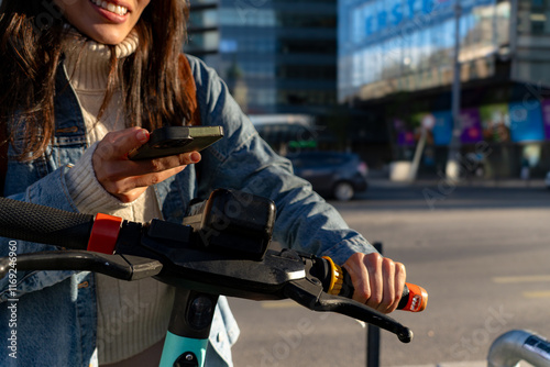 Tourist unlocking a scooter in the city center for a quick ride