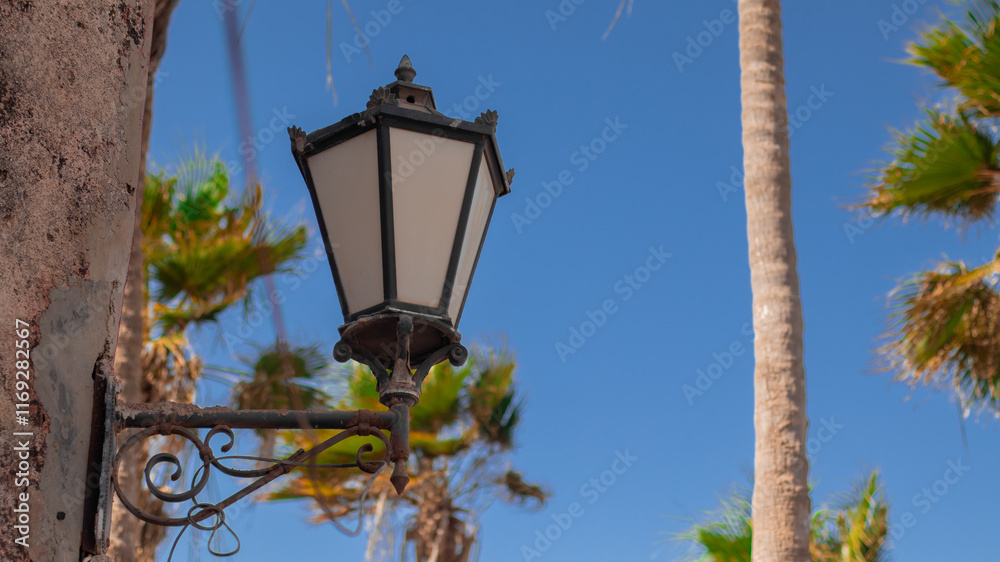 One of colonial lamps on a wall on the slave island of Goree, close to the Dakar, the capital of Senegal. Lamp posted on the wall..