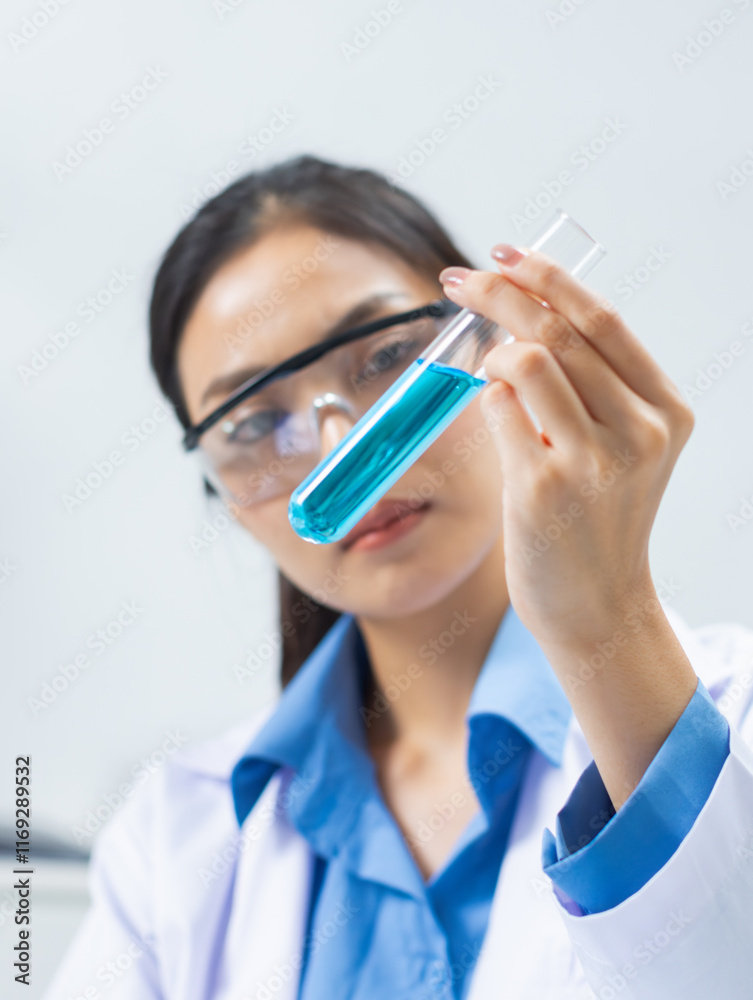 Professional Asian Female scientist uses a test tube to study liquid Simples conducts detailed chemical research contributing to medical research and pharmaceutical development in a laboratory. Professional Asian Female scientist uses a test tube to study liquid Simples conducts detailed chemical research contributing to medical research and pharmaceutical development in a laboratory.