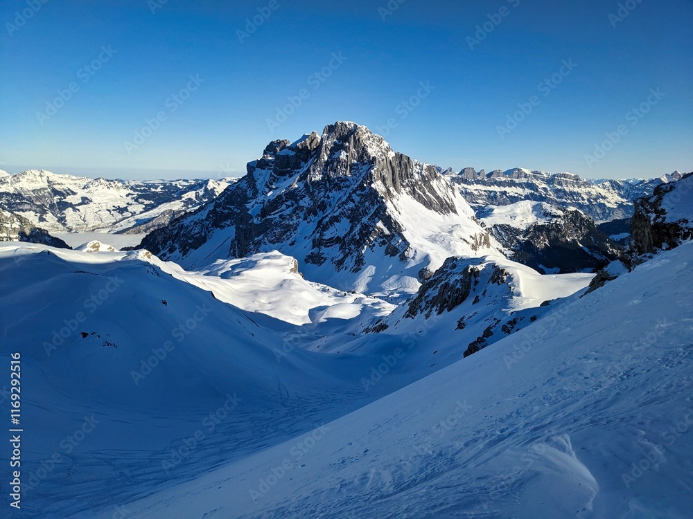 Obraz premium Ski tour in the Glarus Alps with a view of the Mürtschenstock near the Schilt. Ski mountaineering in winter. Winter mountain landscape. High quality photo