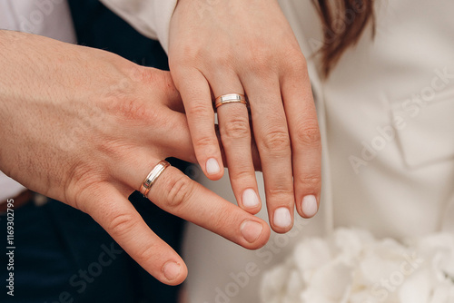 Close-up photo of the fingers of two newlyweds who got engaged