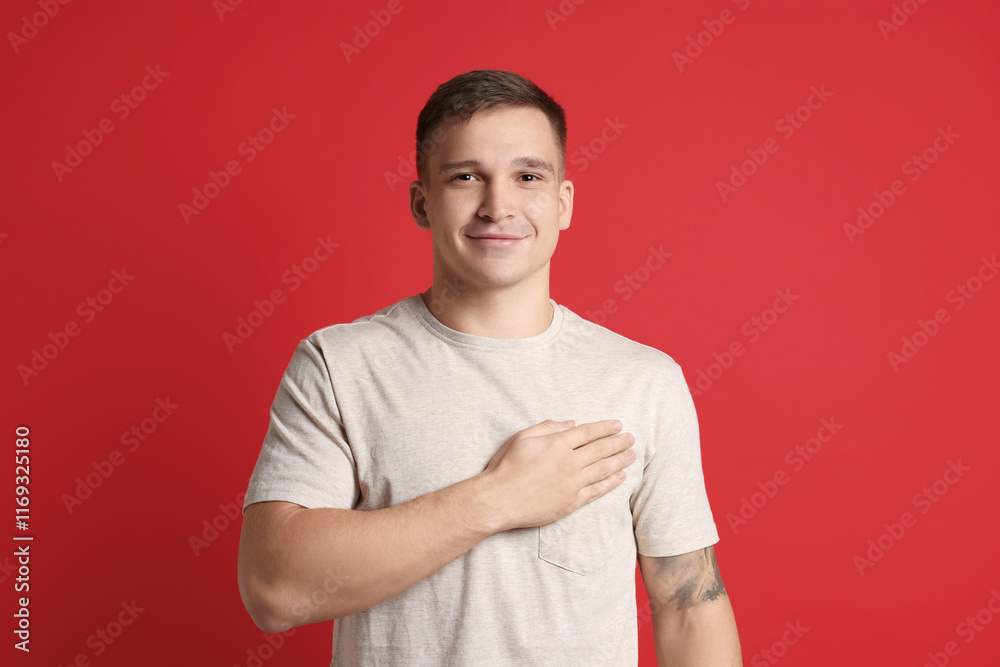 Man making promise on red background. Oath gesture Man making promise on red background. Oath gesture