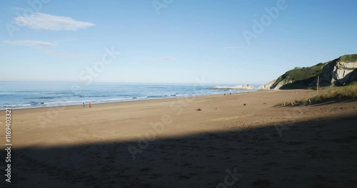 Playa de la Salvaje en Sopelana una parte de la arena esta en sombra y otra no photo