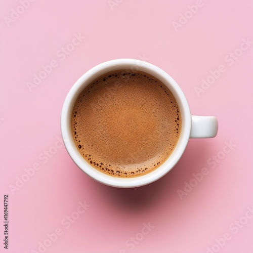 Freshly brewed coffee in a white cup on a soft pink background