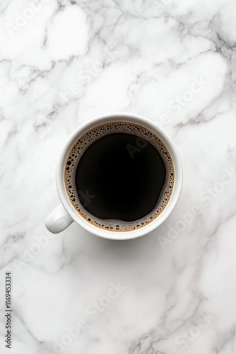 Freshly brewed coffee in a white cup resting on a marble countertop