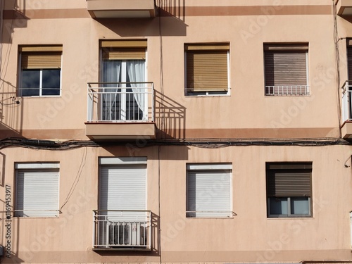 Residential Apartment Building with Closed Windows and Balconies in Daylight