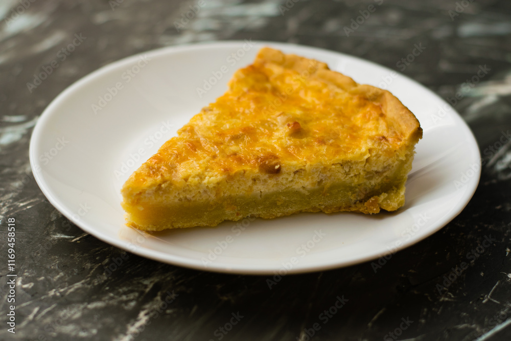 Piece of delicious open pie quiche with chicken, cheese and cream on a white plate, copy space. Food blog concept, recipe writing. Piece of delicious open pie quiche with chicken, cheese and cream on a white plate, copy space. Food blog concept, recipe writing.