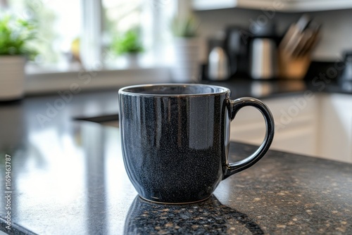 Black ceramic coffee mug on a kitchen countertop with plants in the background