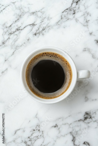 Freshly brewed coffee in a white cup resting on a marble countertop