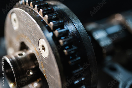 Close-up view of industrial metal gears in motion, symbolizing engineering, machine building, machine construction and precision manufacturing, disassembled car engine, spare parts. Selective focus