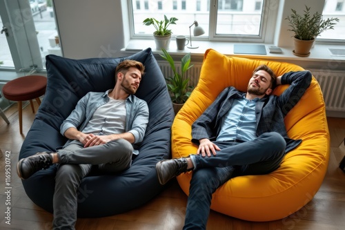 Creative businessmen napping on beanbags in office photo