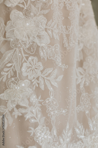 Elegant floral lace detailing on a wedding dress with sparkling sequins, perfect for bridal inspiration, wedding photography, and luxurious design ideas for modern weddings