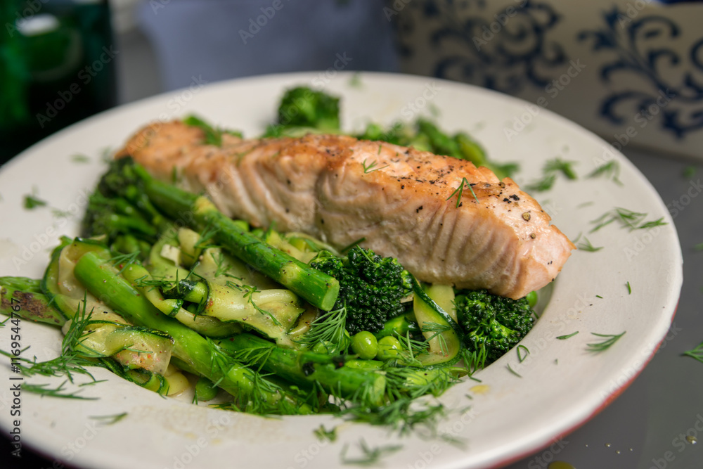 Pan fried salmon with warm green spring salad, fresh and healthy lunch, close up Pan fried salmon with warm green spring salad, fresh and healthy lunch, close up