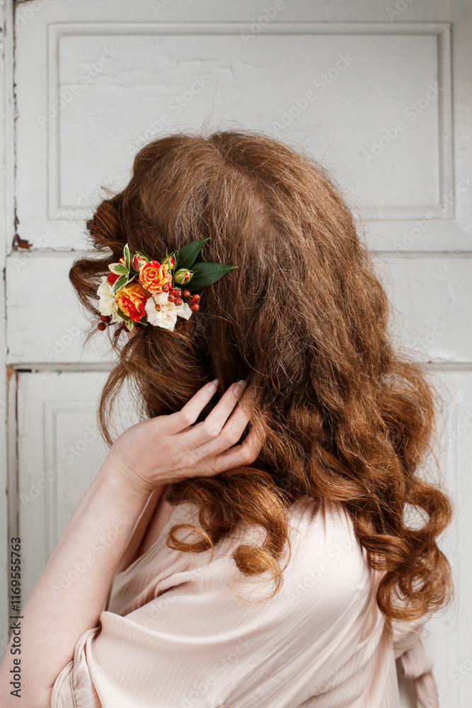 Young woman with fresh flowers in her hair.