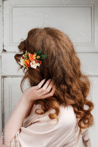 Young woman with fresh flowers in her hair.