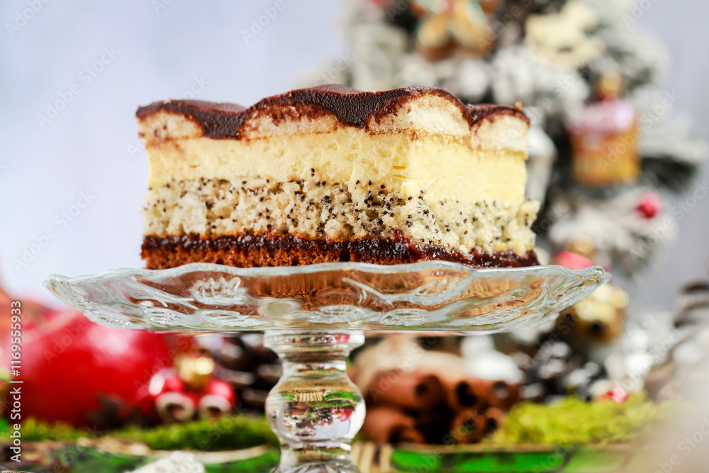 Multi layer cake with vanilla, poppy seed and chocolate among Christmas decorations.