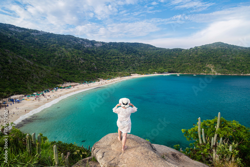 Girl Looking the beach landscape in Arraial do Cabo, Rio de Janeiro. photo