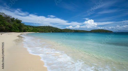 A peaceful beach with crystal clear turquoise water and gentle waves lapping the shore 
