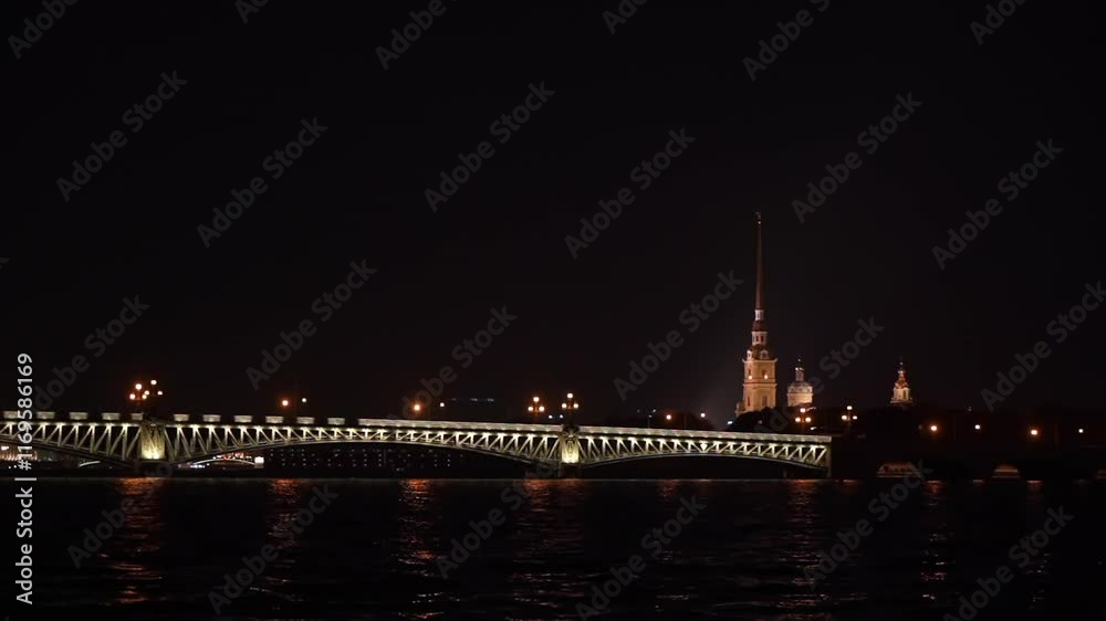 A stunning night view of St. Petersburg featuring illuminated landmarks and reflections on the water. A stunning night view of St. Petersburg featuring illuminated landmarks and reflections on the water.