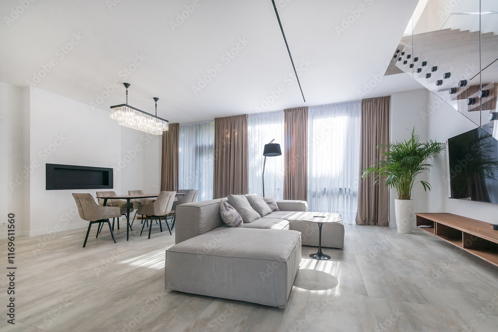 Fototapeta premium Elegant living room, decorated in pastel colors, with a fireplace and stylish furniture. .Stairs with glass railings.