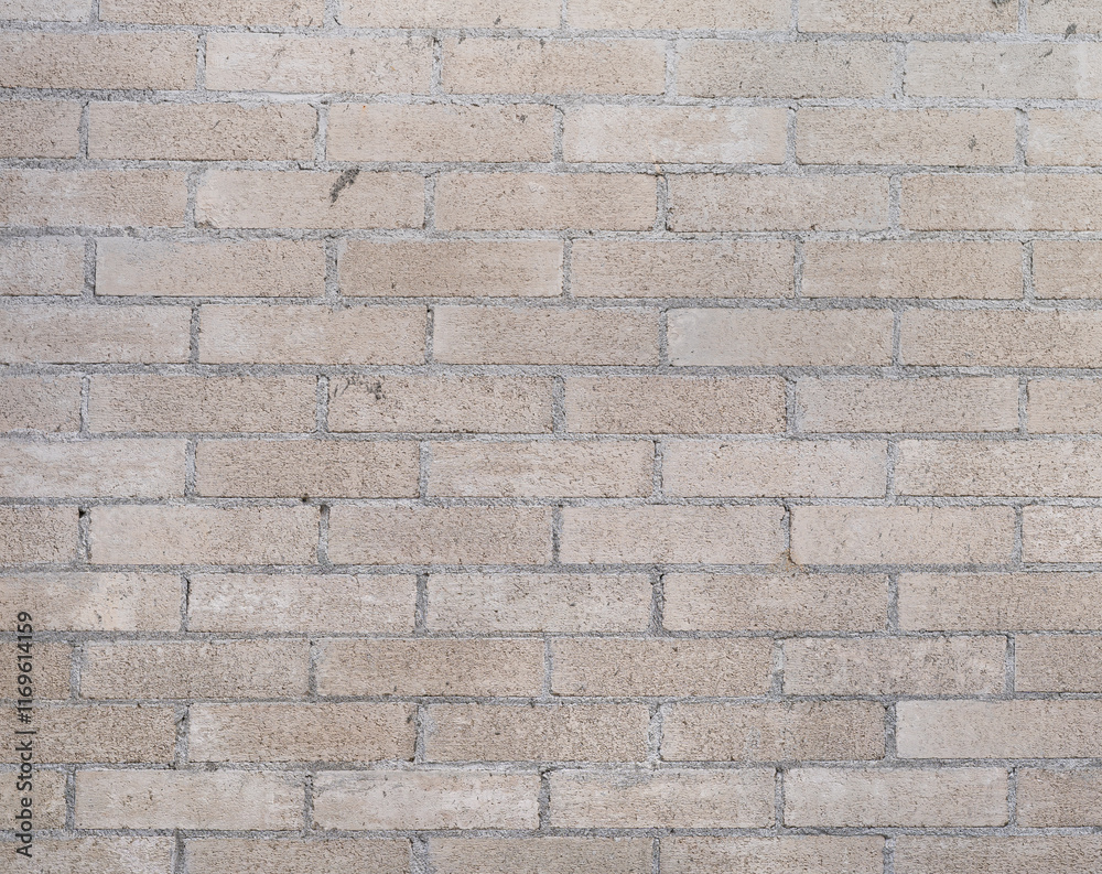 Obraz premium Textura Industrial Detallada: Pared de Adoquines Beige Claro y Taupe con Cemento Gris Claro, Capturando la Estética Rústica de una Fábrica Abandonada, Ideal para Fondos, Presentaciones y Decoración Vi