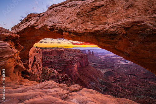 Obraz na płótnie A colorful morning sunrise at the Mesa Arch in the Island in the Sky district of the Canyonlands National Park near Moab in Utah United States. w salonie