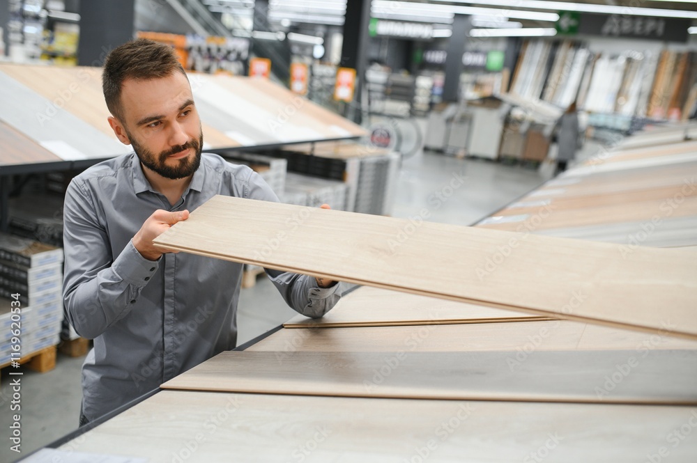 man choosing laminate samples in hardware store man choosing laminate samples in hardware store