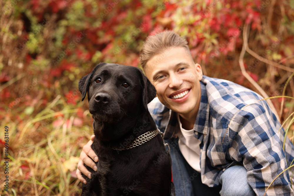 Smiling man with cute dog outdoors on autumn day Smiling man with cute dog outdoors on autumn day