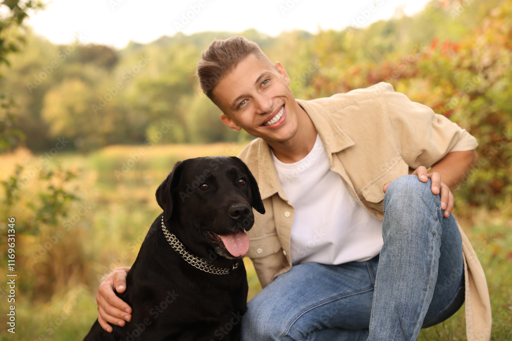 Smiling man with cute dog outdoors on autumn day Smiling man with cute dog outdoors on autumn day