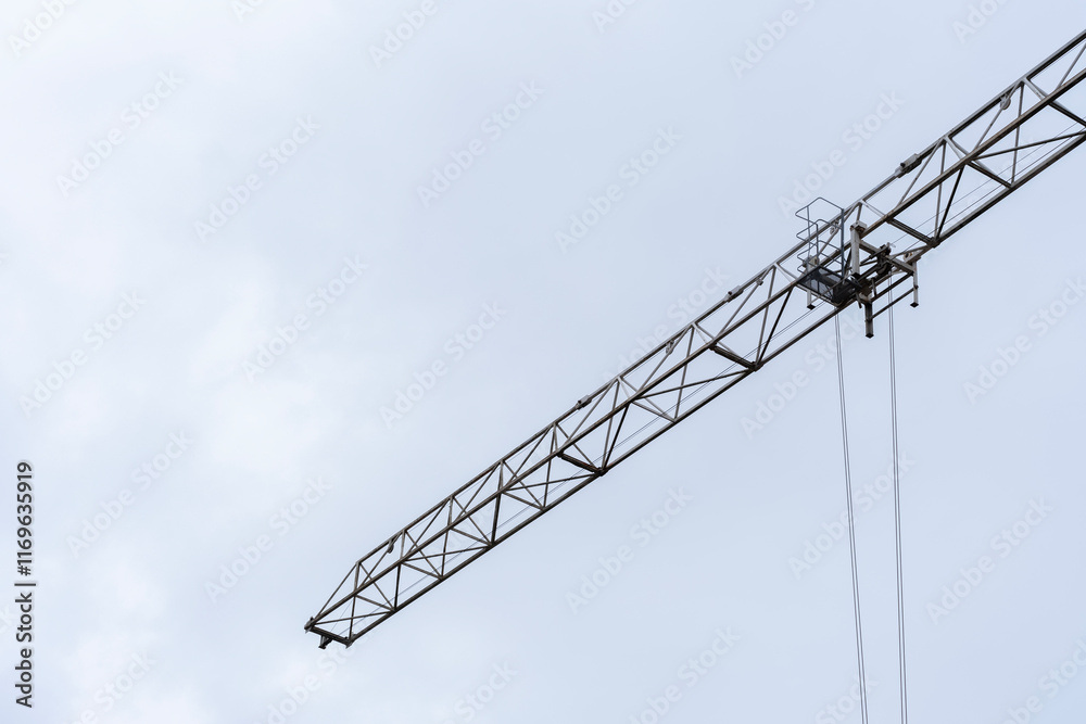 A minimalistic image of a construction crane arm extending into the pale blue sky. The clean lines and modern aesthetic highlight industrial progress and urban development A minimalistic image of a construction crane arm extending into the pale blue sky. The clean lines and modern aesthetic highlight industrial progress and urban development