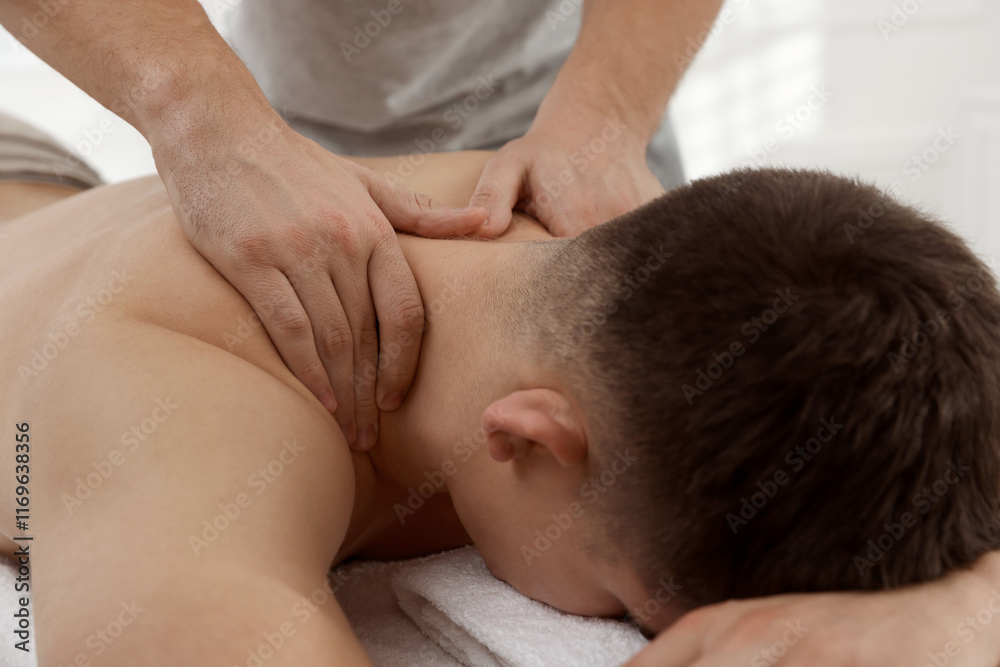 Massage therapist working with patient in clinic, closeup Massage therapist working with patient in clinic, closeup