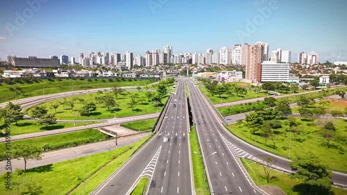 aerial view of a highway in Sao Jose dos Campos, mid size city in Sao Paulo state, Brazil with the city skyline in the background