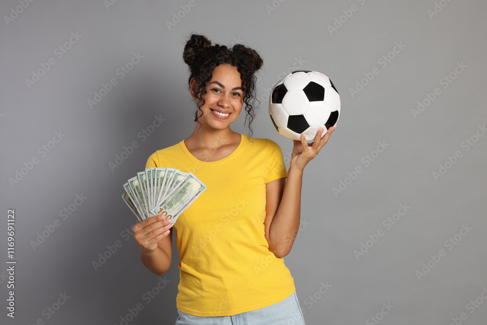 Φωτογραφία Happy woman with money and soccer ball on grey background