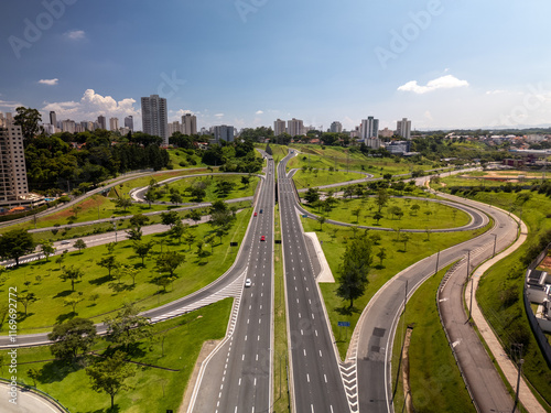 aerial view of a highway in Sao Jose dos Campos, mid size city in Sao Paulo state, Brazil with the city skyline in the background