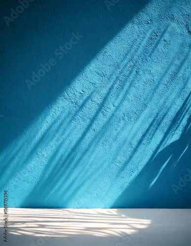 Palm leaves shadow on blue wall background and pastel floor. Summer tropical beach background. Empty room for product presentation. Minimal concept.
