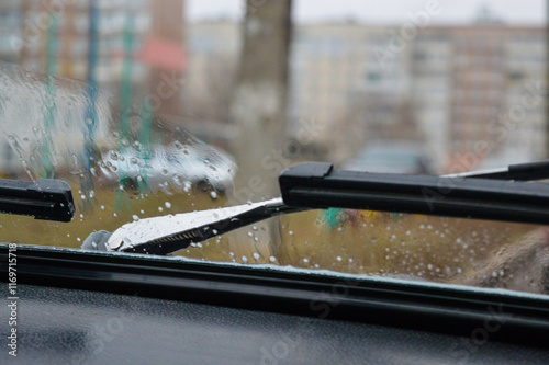 car's dashboard ventilation system and windshield windshield wipers raindrops on the glass wet weather outside vintage textured design nostalgic retro feel automotive collectors rainy-day accessories  photo