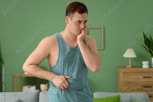 Young man experiencing stom...