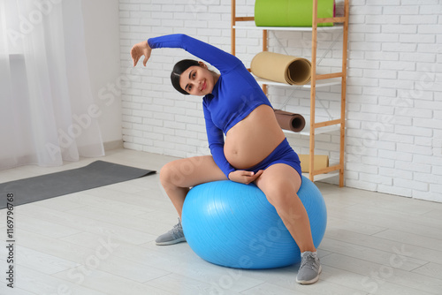 Young pregnant woman doing ...