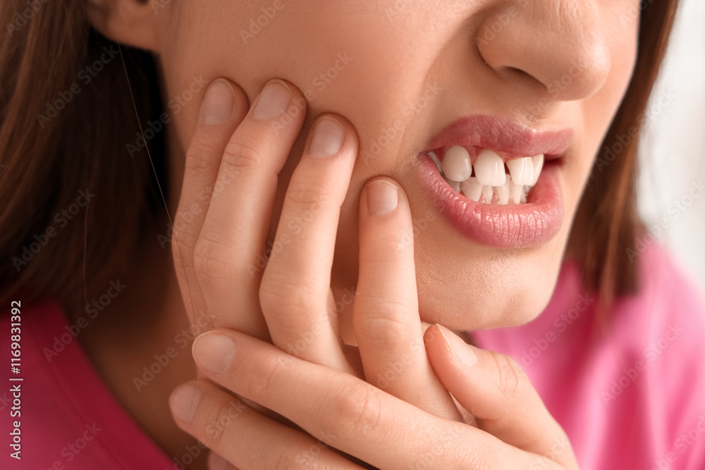 Young woman suffering from toothache in bedroom, closeup Young woman suffering from toothache in bedroom, closeup