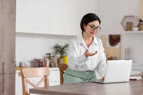 Mature woman with laptop vi...