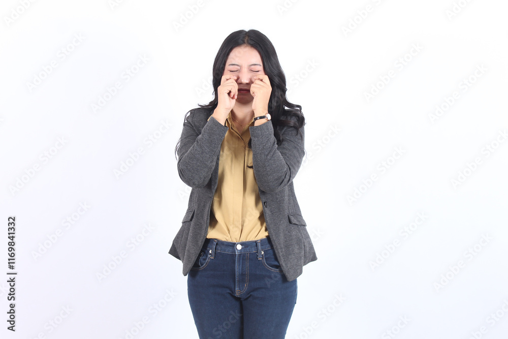 A woman is crying while wearing a yellow shirt and gray Blazer A woman is crying while wearing a yellow shirt and gray Blazer