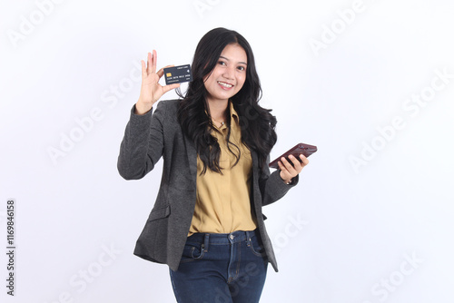 Asian business woman holding credit card using cell phone mobile app paying online