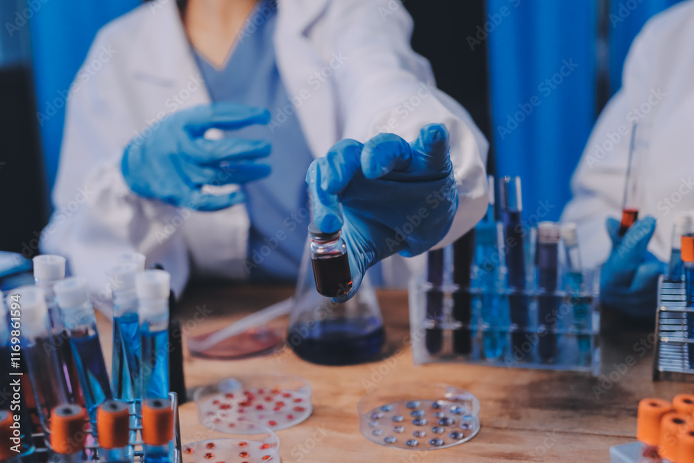 Fototapeta premium Blood test in the laboratory. Laboratory assistant working with the dispenser. Vacuum tubes with blood.
